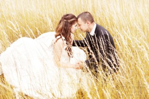 Wedding couple bride and groom  in yellow grass
